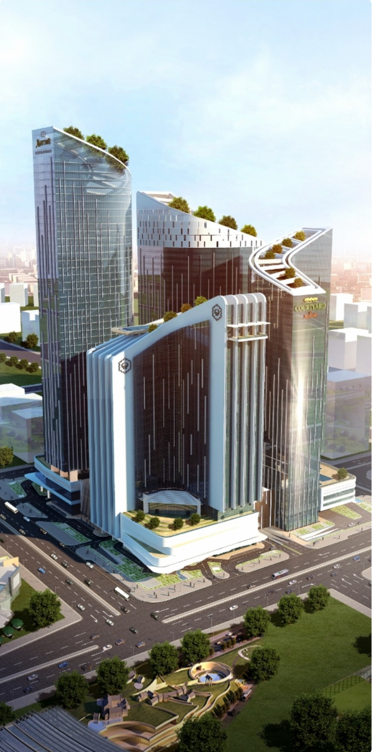 Exterior view of a modern, multi-story building with a sleek, reflective facade in an urban environment.