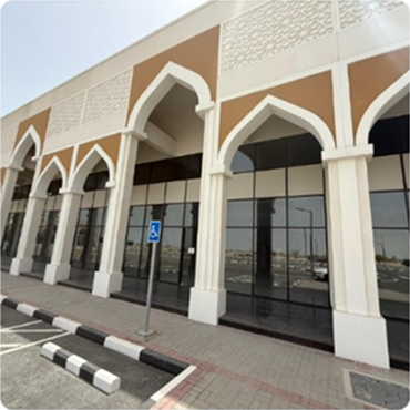 : Exterior view of a building featuring traditional Middle Eastern or Arabic architecture with arched doorways
